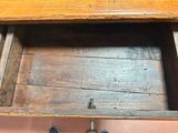 a wooden drawer with a pair of shoes in it