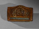 an image of a small wooden box with a carving of a man and a woman