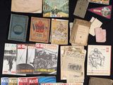 many old books on a table with a black table cloth
