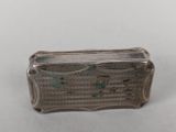 an old silver box sitting on top of a white table