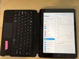 a laptop and a tablet on a table with a cup of coffee