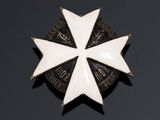 an image of a white and black badge with a star on it