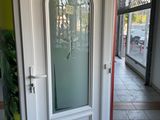 a white door with a glass window in the middle of a room