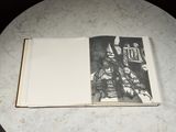 an open book on a table with a drawing on it