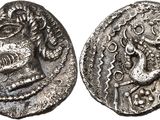 a silver coin with an image of a man and a woman on it