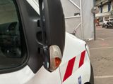 a white truck with red stripes parked in a parking lot