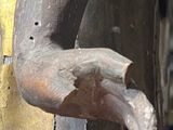 a close up of a statue of a person holding a cell phone