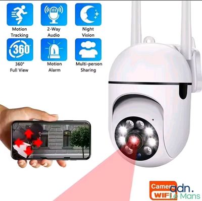 an image of a person holding a smart phone and a camera