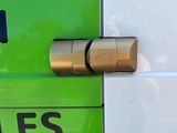 a close up of a green and white bus with the door open
