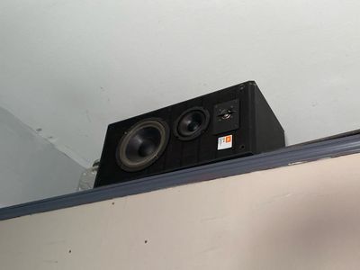 a speaker that is sitting on top of a shelf
