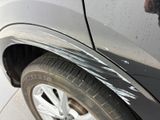 a close up of a car ' s front bumper with scratches on it