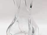 a clear glass vase that is sitting on a white surface