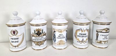 four white and gold canisters are lined up against a white wall