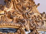 a mirror with a gold frame and a mirror with a mirror on it