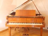 a grand piano in the corner of a room