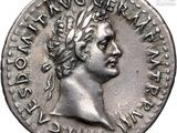 a silver coin with a woman ' s head and a crown on it