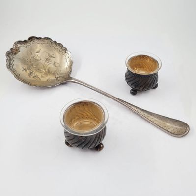 two cups of coffee and a spoon on the table