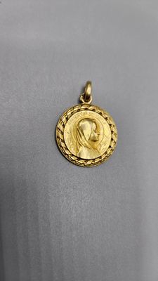 a gold coin with a woman ' s face on it