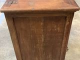 an old wooden cabinet with a metal latch on the door
