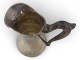 a silver pitcher with a handle on a white background