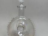 a clear glass bottle with a stopper on top of it