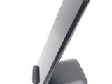a phone that is sitting on a stand on a table