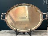 a silver tray with a mirror on it on a table