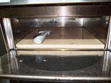 a metal oven that has a white object inside of it