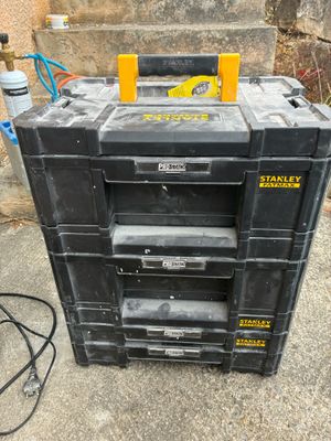 a stack of tool boxes sitting on the ground