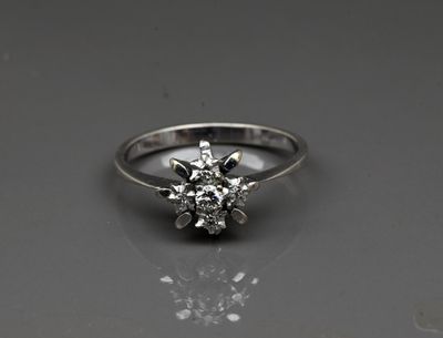 a close up of a diamond ring sitting on top of a table