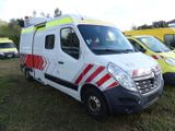 three ambulances parked next to each other in a field