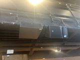 many speakers that are on the ceiling of a building