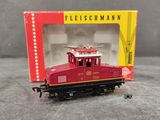 a red train car in a box on a table