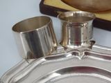 a silver plate with a silver cup on it and a silver plate with a silver cup on it