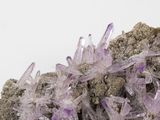 purple crystals on a rock on a white background