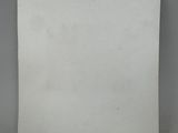a white piece of paper with a blue sticker on it