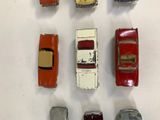 several toy cars are arranged in a row on a white surface
