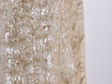a close up of a shawl with a flower in it