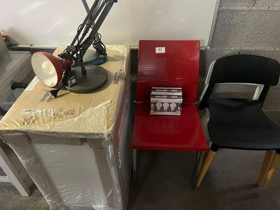 two chairs sitting next to a table with a lamp on it