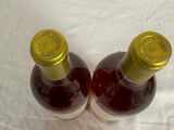 two bottles of wine that are sitting on a table