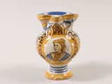 a blue and white vase with a picture of a woman on it