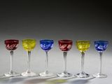 quatre verres à vin sont alignés sur une table