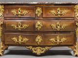a marble top chest of drawers with gold decoration