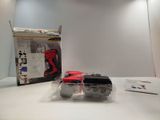 a red and black toy car sitting on a white table