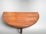 an old wooden table with a curved top on a white background