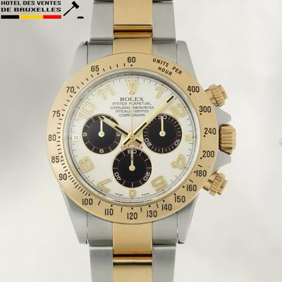 a silver and gold watch with a white face