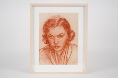 a drawing of a woman ' s face in a wooden frame
