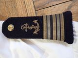 a close up of a military officer ' s uniform on a white shirt