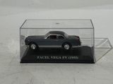 a small toy car in a clear case on a table