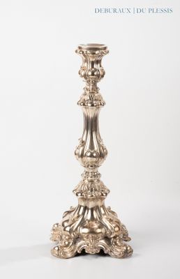 a silver candle that is sitting on a table